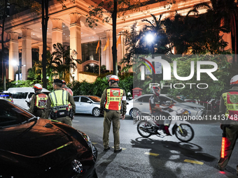 Police officers are standing outside the Grand Hyatt Erawan Hotel in Bangkok, Thailand, on July 16, 2024. Local news reports are saying that...