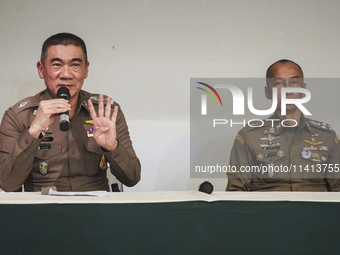 Metropolitan Police Bureau Commissioner Thiti Sangsawang is speaking as National Police Chief Torsak Sukvimol is looking on during a press c...