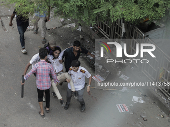 An injured anti-quota protestor is being taken to a hospital during a clash with the pro-government student wing in Dhaka, Bangladesh, on Ju...