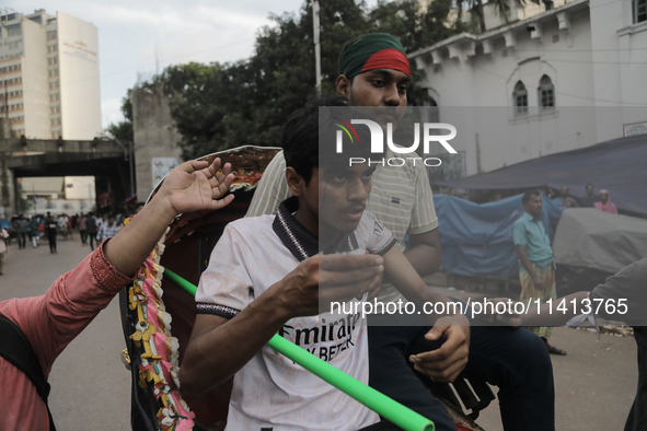 An injured anti-quota protestor is being taken to a hospital during a clash with the pro-government student wing in Dhaka, Bangladesh, on Ju...