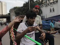 An injured anti-quota protestor is being taken to a hospital during a clash with the pro-government student wing in Dhaka, Bangladesh, on Ju...