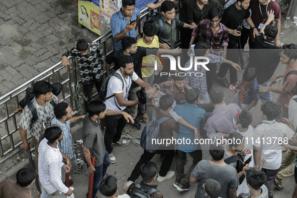 An injured anti-quota protestor is being taken to a hospital during a clash with the pro-government student wing in Dhaka, Bangladesh, on Ju...