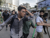 An injured anti-quota protestor is being taken to a hospital during a clash with the pro-government student wing in Dhaka, Bangladesh, on Ju...