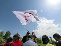 A Kashmiri Shia Muslim man is waving a flag during a procession in the interiors of Dal Lake in Srinagar, Indian Administered Kashmir, on Ju...