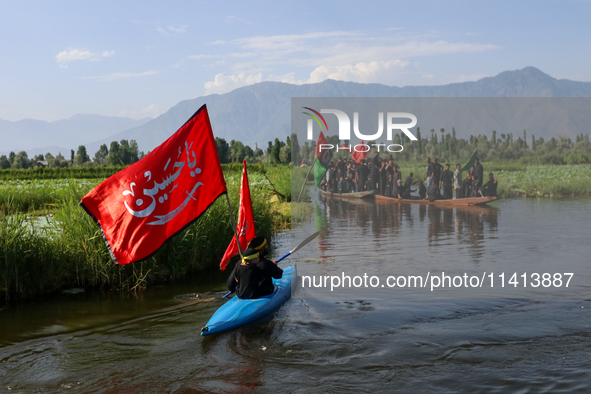 Kashmiri Shia Muslims are mourning as they are taking part in the Ashura procession in boats in the interiors of Dal Lake in Srinagar, India...