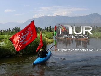 Kashmiri Shia Muslims are mourning as they are taking part in the Ashura procession in boats in the interiors of Dal Lake in Srinagar, India...