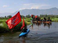 Kashmiri Shia Muslims are mourning as they are taking part in the Ashura procession in boats in the interiors of Dal Lake in Srinagar, India...