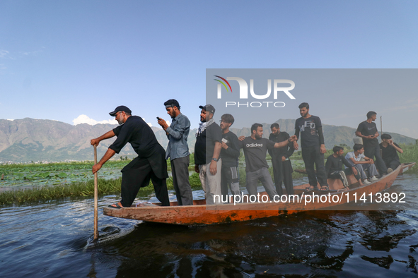 Kashmiri Shia Muslims are mourning as they are taking part in the Ashura procession in boats in the interiors of Dal Lake in Srinagar, India...