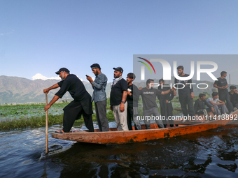 Kashmiri Shia Muslims are mourning as they are taking part in the Ashura procession in boats in the interiors of Dal Lake in Srinagar, India...