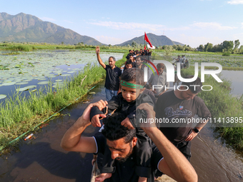 Kashmiri Shia Muslims are mourning as they are taking part in the Ashura procession in boats in the interiors of Dal Lake in Srinagar, India...