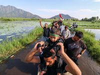 Kashmiri Shia Muslims are mourning as they are taking part in the Ashura procession in boats in the interiors of Dal Lake in Srinagar, India...