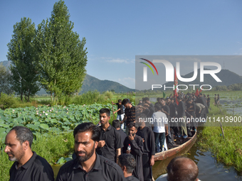 Kashmiri Shia Muslims are mourning as they are taking part in the Ashura procession in boats in the interiors of Dal Lake in Srinagar, India...