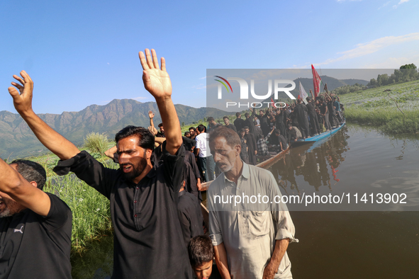 Kashmiri Shia Muslims are mourning as they are taking part in the Ashura procession in boats in the interiors of Dal Lake in Srinagar, India...