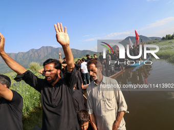 Kashmiri Shia Muslims are mourning as they are taking part in the Ashura procession in boats in the interiors of Dal Lake in Srinagar, India...