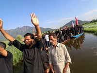 Kashmiri Shia Muslims are mourning as they are taking part in the Ashura procession in boats in the interiors of Dal Lake in Srinagar, India...