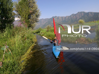 Kashmiri Shia Muslims are mourning as they are taking part in the Ashura procession in boats in the interiors of Dal Lake in Srinagar, India...