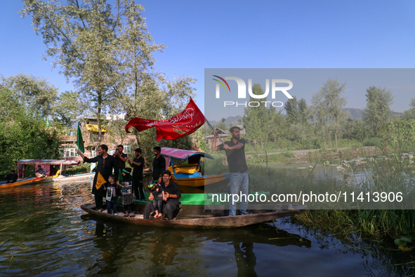 Kashmiri Shia Muslims are mourning as they are taking part in the Ashura procession in boats in the interiors of Dal Lake in Srinagar, India...