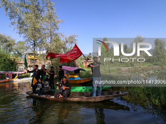 Kashmiri Shia Muslims are mourning as they are taking part in the Ashura procession in boats in the interiors of Dal Lake in Srinagar, India...