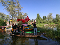 Kashmiri Shia Muslims are mourning as they are taking part in the Ashura procession in boats in the interiors of Dal Lake in Srinagar, India...