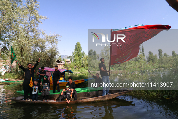 Kashmiri Shia Muslims are mourning as they are taking part in the Ashura procession in boats in the interiors of Dal Lake in Srinagar, India...