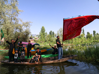 Kashmiri Shia Muslims are mourning as they are taking part in the Ashura procession in boats in the interiors of Dal Lake in Srinagar, India...