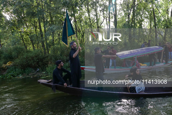 Kashmiri Shia Muslims are mourning as they are taking part in the Ashura procession in boats in the interiors of Dal Lake in Srinagar, India...