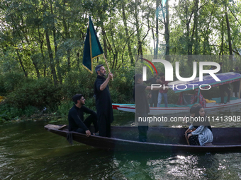 Kashmiri Shia Muslims are mourning as they are taking part in the Ashura procession in boats in the interiors of Dal Lake in Srinagar, India...