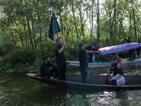 Kashmiri Shia Muslims are mourning as they are taking part in the Ashura procession in boats in the interiors of Dal Lake in Srinagar, India...