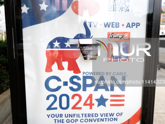 A C-SPAN advertisement at a bus stop is seen covered by political stickers near Red Arrow Park in Milwaukee, Wisconsin on July 16, 2024. (