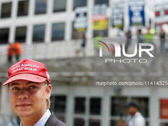 A supporter of Donald Trump walks past a protest at Red Arrow Park in Milwaukee, Wisconsin on July 16, 2024 during the Republican National C...