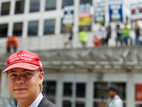 A supporter of Donald Trump walks past a protest at Red Arrow Park in Milwaukee, Wisconsin on July 16, 2024 during the Republican National C...