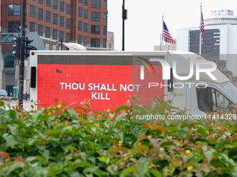 A truck displaying activists' messages is parked in the street adjacent to Red Arrow Park in Milwaukee, Wisconsin on July 16, 2024 as demons...