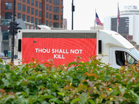 A truck displaying activists' messages is parked in the street adjacent to Red Arrow Park in Milwaukee, Wisconsin on July 16, 2024 as demons...