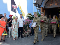 Servicemen are leaving St. Michael's Golden-Domed Cathedral after the memorial service of the commander of the OUN volunteer battalion, Myko...