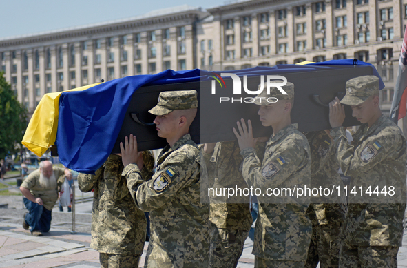 Servicewomen are carrying the coffin of the commander of the OUN volunteer battalion Mykola Kokhanivskyi, who died near Vovchansk in Kharkiv...