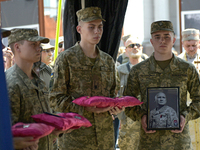 Servicemen are holding the portrait and decorations of the commander of the OUN volunteer battalion Mykola Kokhanivskyi, who died near Vovch...