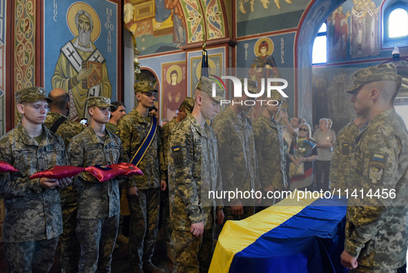 Servicemen are flanking the coffin of the commander of the OUN volunteer battalion Mykola Kokhanivskyi, who died near Vovchansk in Kharkiv r...