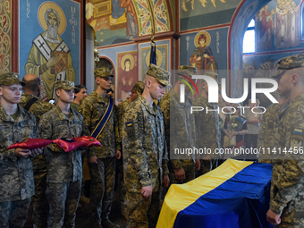 Servicemen are flanking the coffin of the commander of the OUN volunteer battalion Mykola Kokhanivskyi, who died near Vovchansk in Kharkiv r...