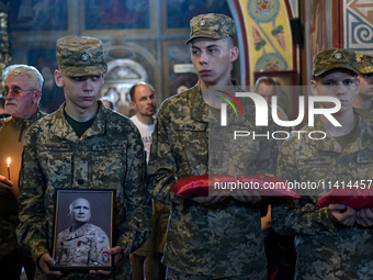 Servicemen are holding the portrait and decorations of the commander of the OUN volunteer battalion Mykola Kokhanivskyi, who died near Vovch...