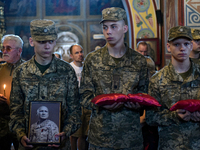 Servicemen are holding the portrait and decorations of the commander of the OUN volunteer battalion Mykola Kokhanivskyi, who died near Vovch...