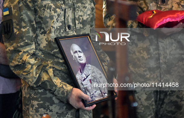 Servicemen are holding the portrait and decorations of the commander of the OUN volunteer battalion Mykola Kokhanivskyi, who died near Vovch...