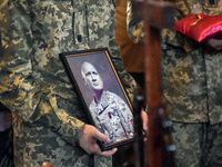 Servicemen are holding the portrait and decorations of the commander of the OUN volunteer battalion Mykola Kokhanivskyi, who died near Vovch...