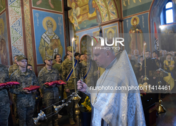 A priest is swinging a censer during a memorial service for the commander of the OUN volunteer battalion Mykola Kokhanivskyi, who died near...