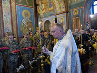 A priest is swinging a censer during a memorial service for the commander of the OUN volunteer battalion Mykola Kokhanivskyi, who died near...