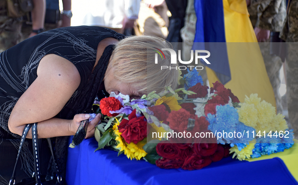 A woman is crying over the coffin of the commander of the OUN volunteer battalion Mykola Kokhanivskyi, who died near Vovchansk in Kharkiv re...