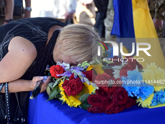 A woman is crying over the coffin of the commander of the OUN volunteer battalion Mykola Kokhanivskyi, who died near Vovchansk in Kharkiv re...