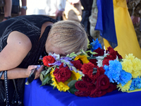 A woman is crying over the coffin of the commander of the OUN volunteer battalion Mykola Kokhanivskyi, who died near Vovchansk in Kharkiv re...