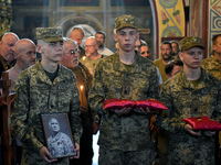 Servicemen are holding the portrait and decorations of the commander of the OUN volunteer battalion Mykola Kokhanivskyi, who died near Vovch...