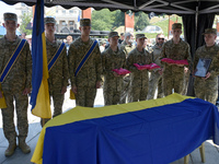 Servicemen are holding the portrait and decorations of the commander of the OUN volunteer battalion Mykola Kokhanivskyi, who died near Vovch...