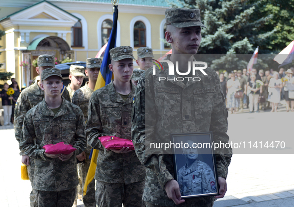 Servicemen are entering St. Michael's Golden-Domed Cathedral after the memorial service of the commander of the OUN volunteer battalion Myko...